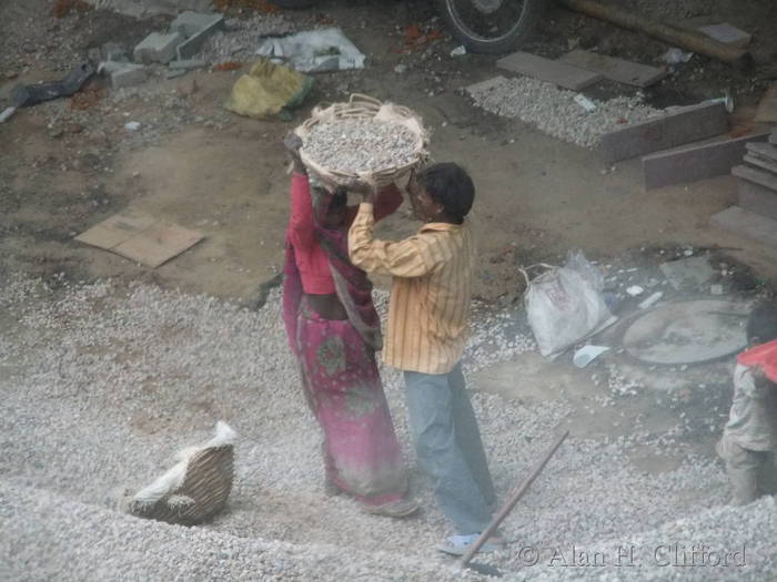 Women&rsquo;s lib. in action:  carrying gravel